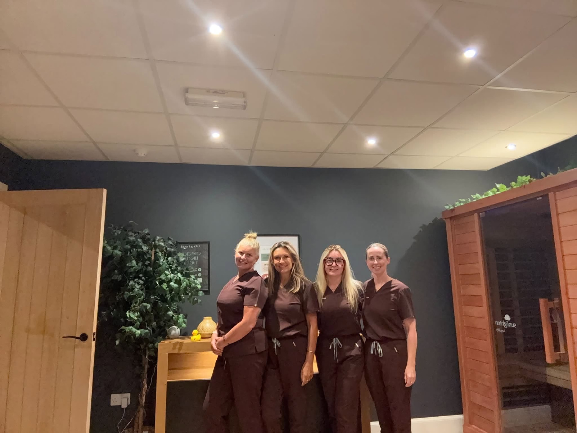 Rollo House therapists beside the infrared sauna at the Longniddry clinic